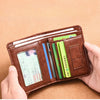 A brown PU leather men's wallet is shown being held, displaying several cards.
