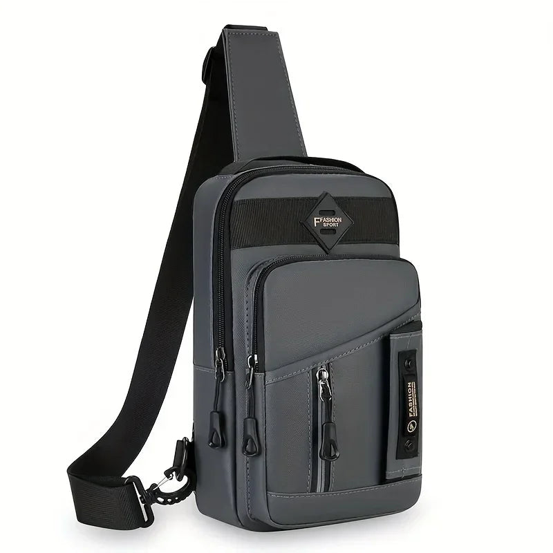 A dark gray adjustable crossbody sling bag with multiple zippered compartments and a black strap.