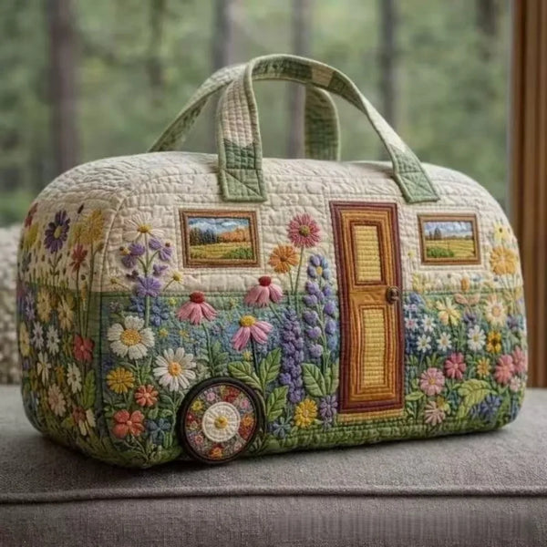 A quilted travel duffel bag featuring a floral pattern in shades of green, yellow, and pink.