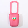 A pink silicone cup holder with a green and orange face design.