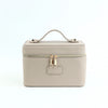 A beige PU leather makeup bag with a top handle and zipper closure.