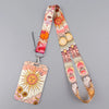 A colorful patterned lanyard with a sun design attached to a key ring.