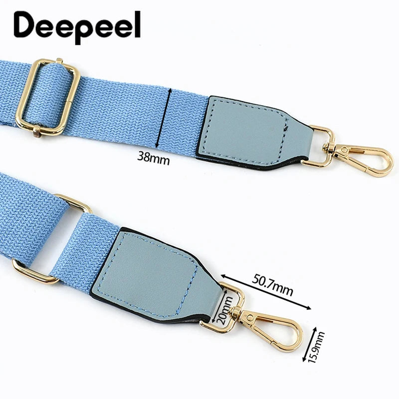 A light blue canvas cotton bag strap with gray accents and metal hooks.