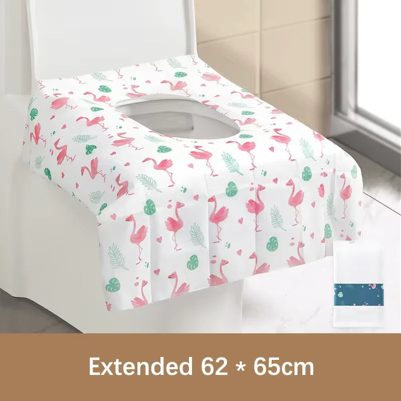 A rolled disposable toilet seat cover in pink and green floral pattern displayed on a white surface.