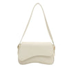 A cream vintage curved flap shoulder bag made of soft faux leather.