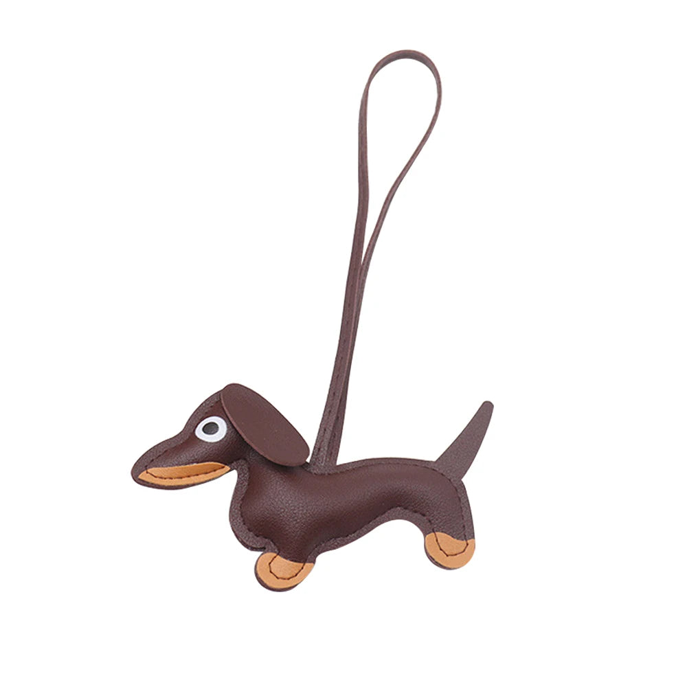 A brown leather dachshund charm with a loop for a keychain.
