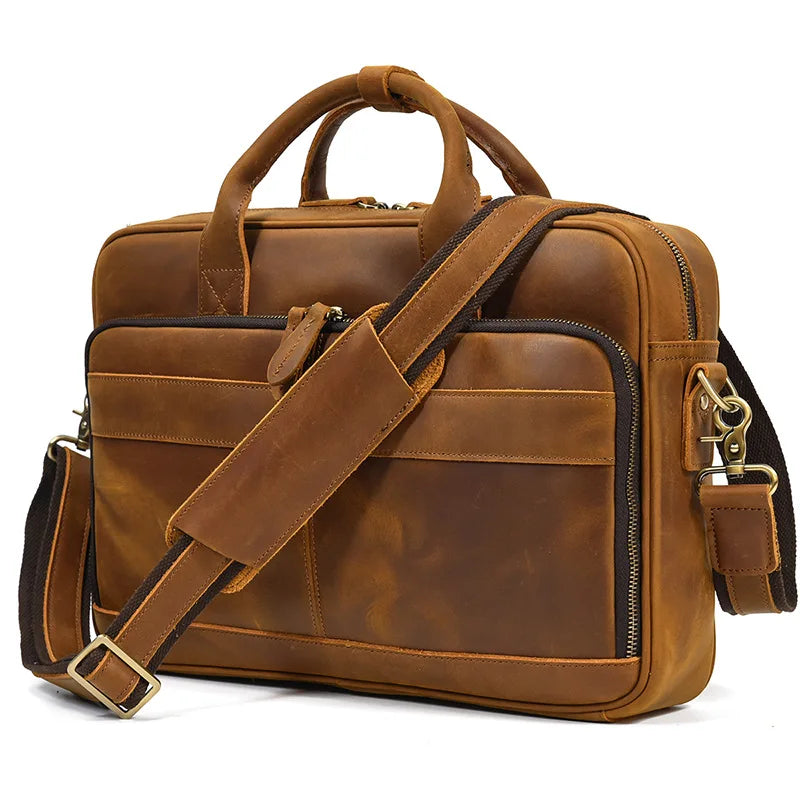 A brown vintage genuine leather briefcase with leather straps and a padded compartment.