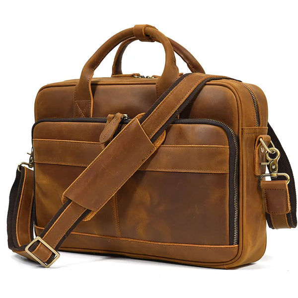 A brown vintage genuine leather briefcase with leather straps and a padded compartment.
