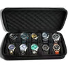 A black leather watch organizer travel case containing multiple wristwatches.