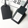 A black PU leather luggage tag with a rectangular identification area and a strap.
