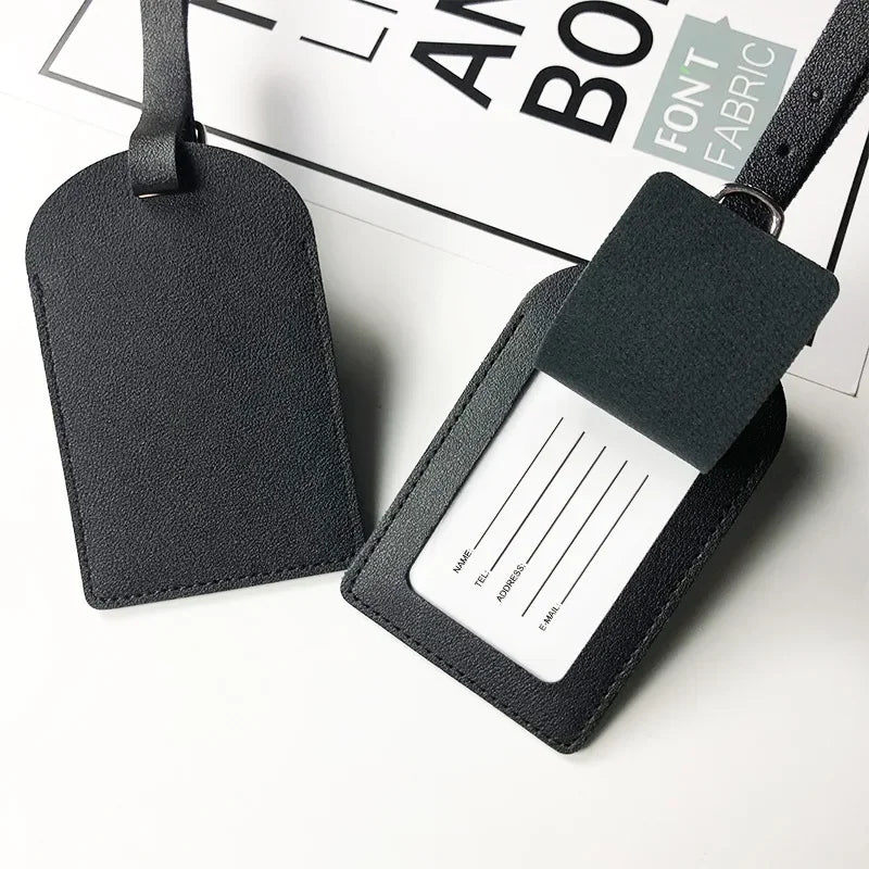 A black PU leather luggage tag with a rectangular identification area and a strap.