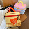 A yellow insulated lunch bag with a heart design and checkered pattern is shown next to a pink and blue patterned lunch box.