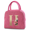 Pink insulated canvas lunch bag featuring a gold letter H and floral design