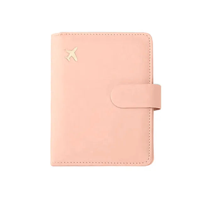 A light pink RFID-blocking travel passport organizer with a card slot and a flap closure.