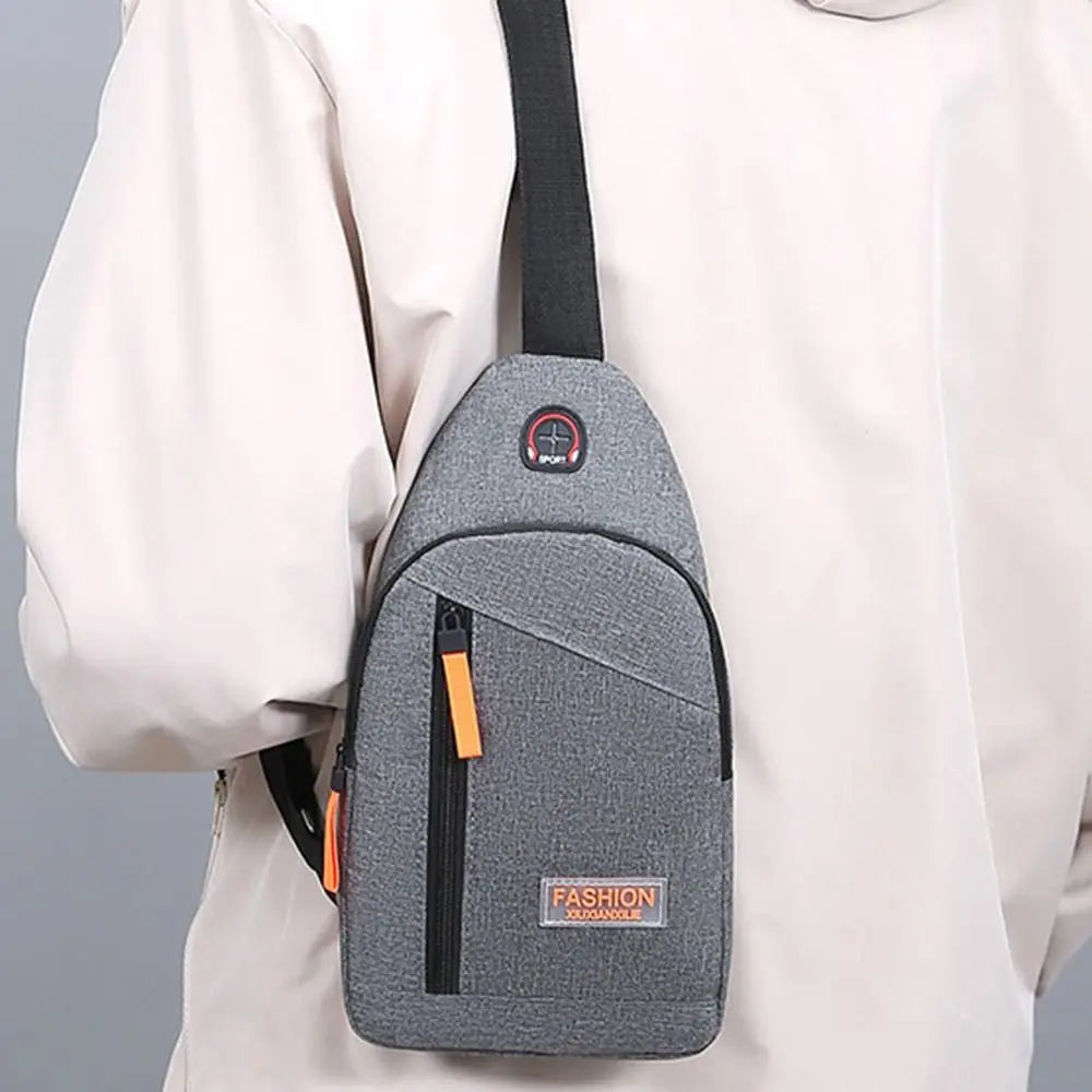 A gray lightweight oxford cloth crossbody bag is shown attached to a white sleeve.