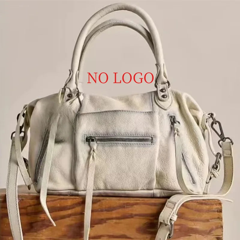 A cream-colored retro motorcycle PU leather crossbody shoulder bag with a top handle and adjustable strap.