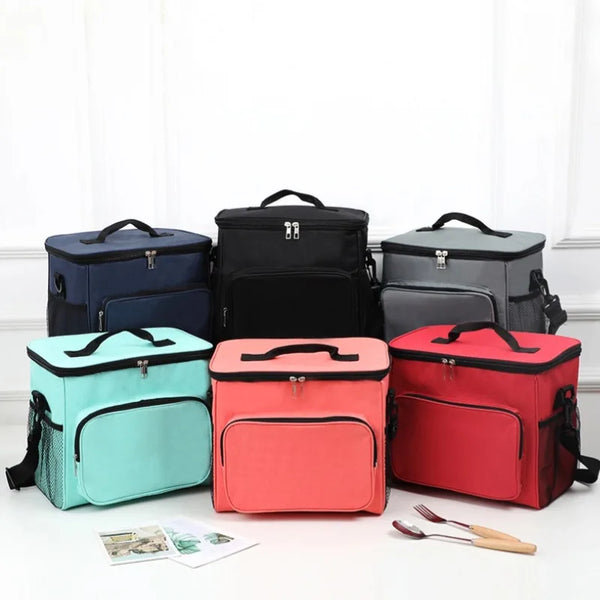 A set of three insulated reusable lunch bags in navy blue, black, and red resting on a white surface.