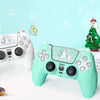 A teal silicone grip cover for a PlayStation 5 controller featuring a cat design, placed on a white surface.