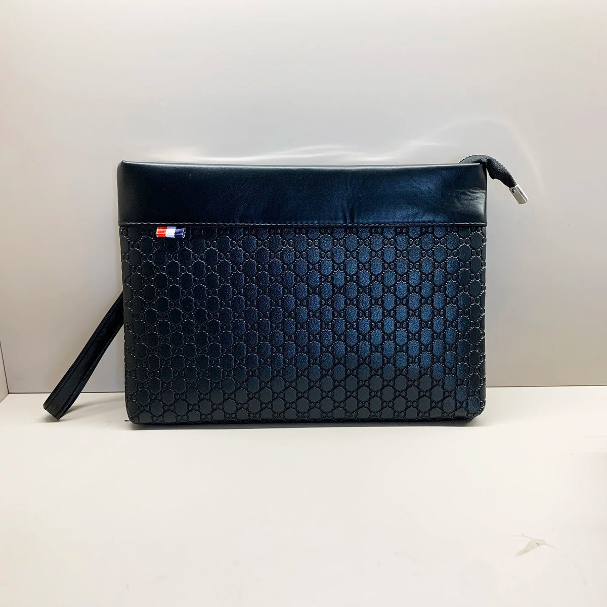 A dark blue quilted PU leather clutch bag with a flap and a small leather strap.