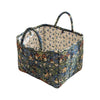 A quilted fabric storage basket with carry handles featuring a floral pattern in blue, green, and brown tones.