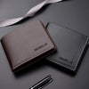 A dark brown men's PU leather folding wallet resting on a dark surface with a ribbon and a pen.