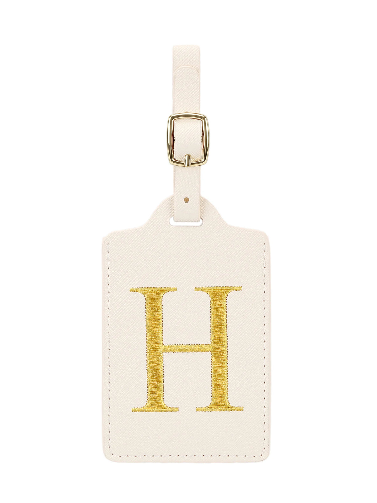 Étiquette de bagage en cuir crème rectangulaire avec un H brodé en or et un clip métallique argenté.