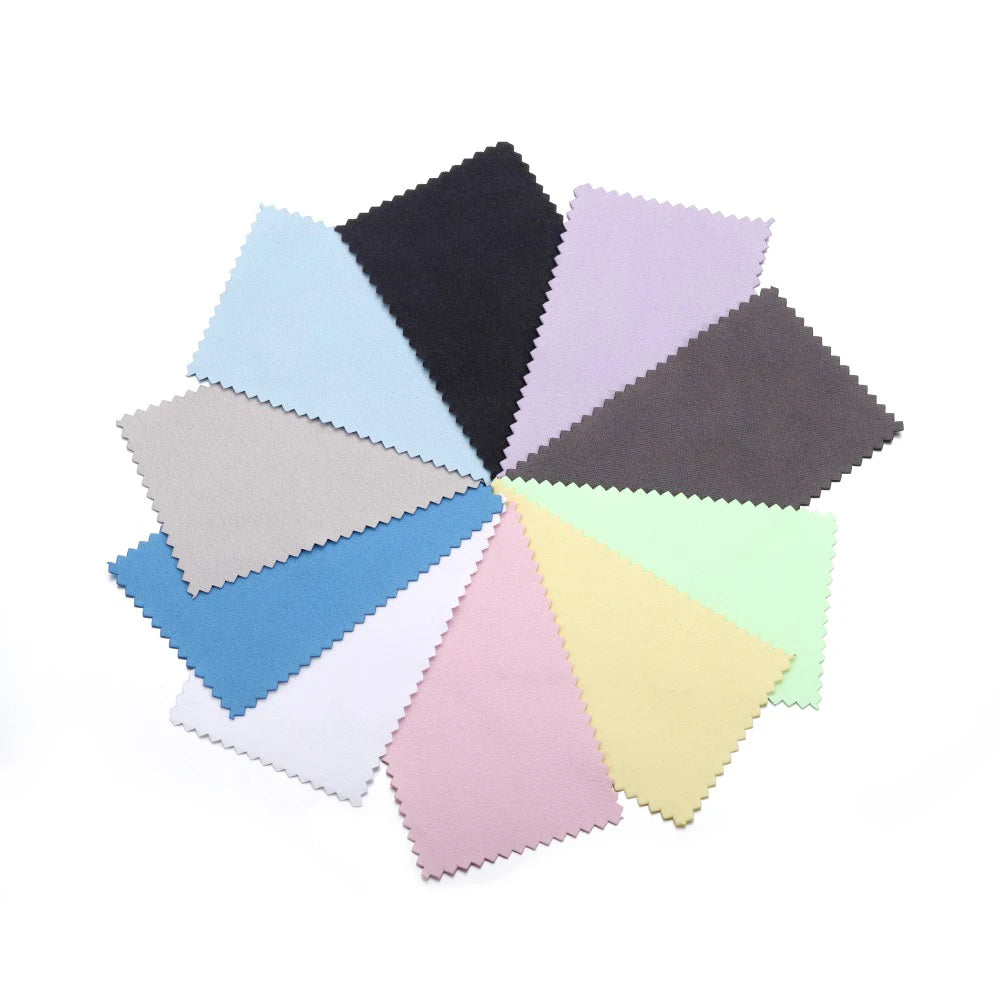 A collection of various colored polishing cloths, including shades of blue, purple, gray, and black.