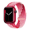 A pink and red braided stretch band is shown around a red Apple Watch.