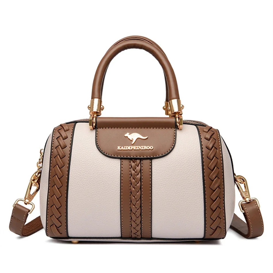 A tan and beige leather shoulder crossbody bag with a woven texture and gold hardware.