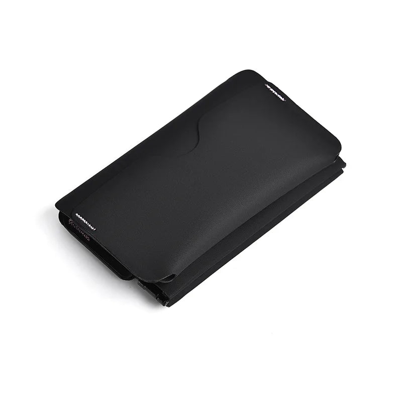 A black magnetic foldable ID card holder and coin purse shown from above.