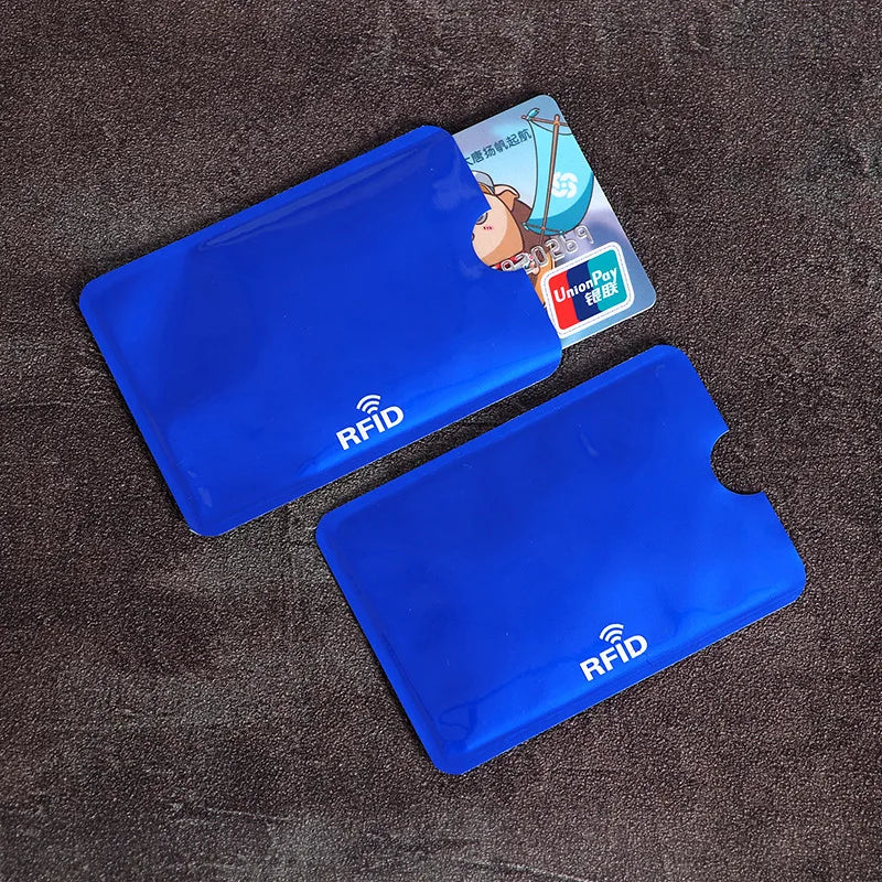 Two blue RFID protection card sleeves are displayed on a dark surface next to a UnionPay card.