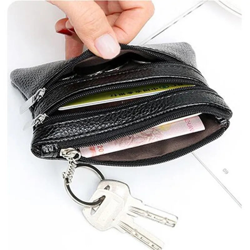A black PU leather clutch wallet is shown open, with a silver key attached to the zipper pull.
