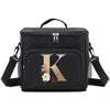 Black insulated canvas lunch bag featuring a gold letter K design and dual handles.