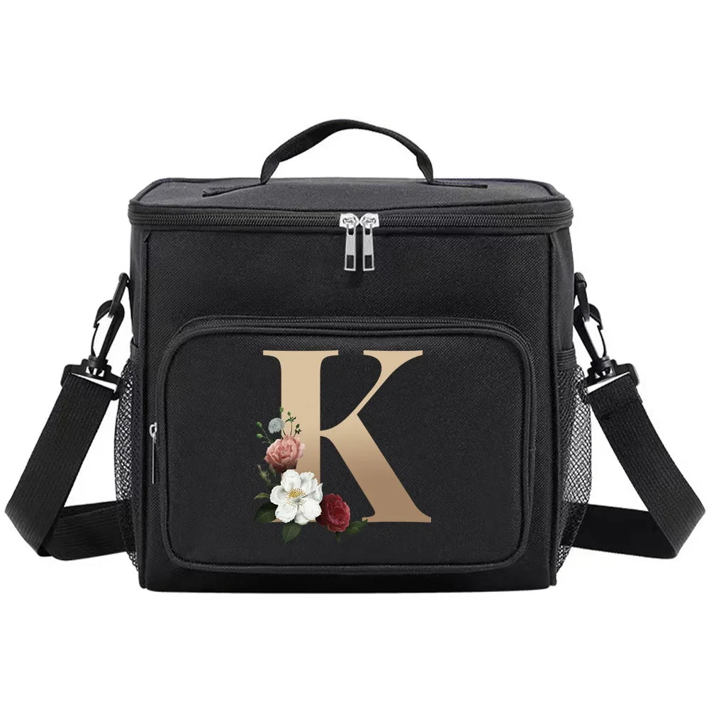Black insulated canvas lunch bag featuring a gold letter K design and dual handles.