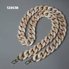 A close-up of a light beige acrylic resin detachable bag chain strap with a link pattern.