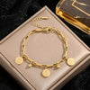 Gold stainless steel charm bracelet with a portrait pendant displayed in a box.