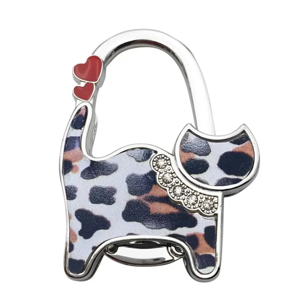 Silver cat-shaped handbag hooks with a leopard print design