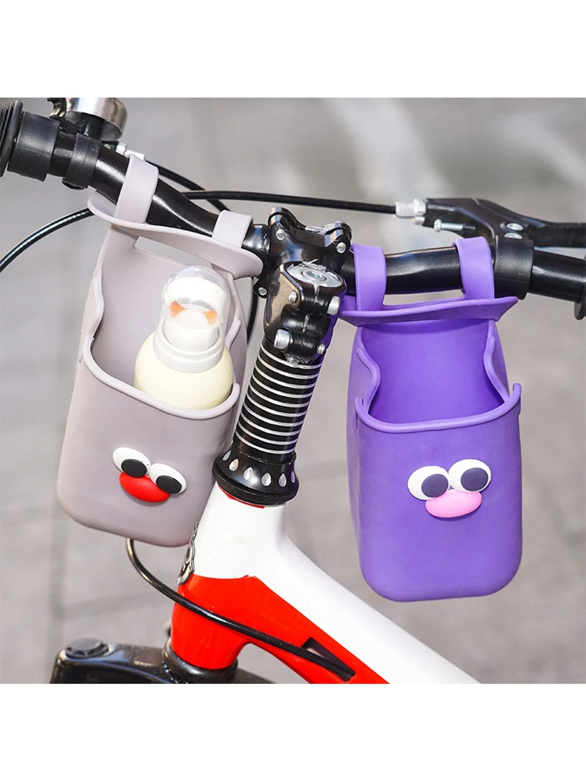 A purple silicone cup holder is mounted on a bicycle handlebar, designed for holding cups or bottles.