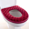 A deep red plush waterproof toilet seat cover is shown installed on a white toilet bowl.