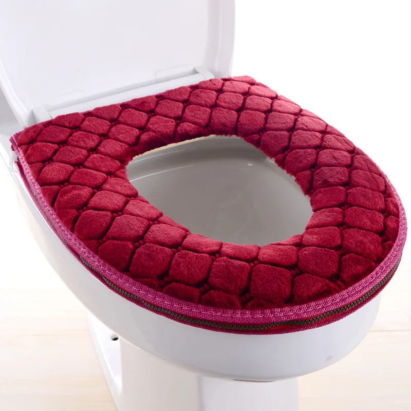 A deep red plush waterproof toilet seat cover is shown installed on a white toilet bowl.