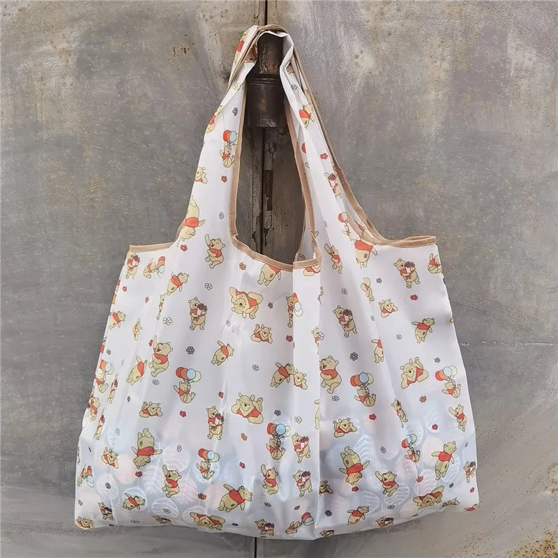 A white reusable shopping bag with a floral pattern is hanging on a metal hook.