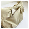 A light beige soft nylon crossbody shoulder bag with a zipper and decorative tassel details.