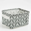 A gray and white patterned foldable cotton linen storage basket with a light beige handle.
