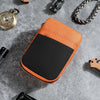 An orange and black portable multi-tool organizer pouch resting on a gray surface with various tools nearby.