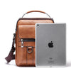A brown vintage PU leather crossbody messenger bag with a leather strap and a silver iPad inside.
