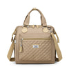 Sac de lunch isotherme beige avec motif matelassé et sangles en cuir.