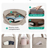 A beige travel duffle bag showing various internal compartments and pockets for organization.