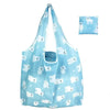 Light blue foldable tote bag featuring a pattern of white cat faces for grocery and storage.