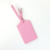 A pink PU leather luggage tag with a silver clip attached to a pink strap.