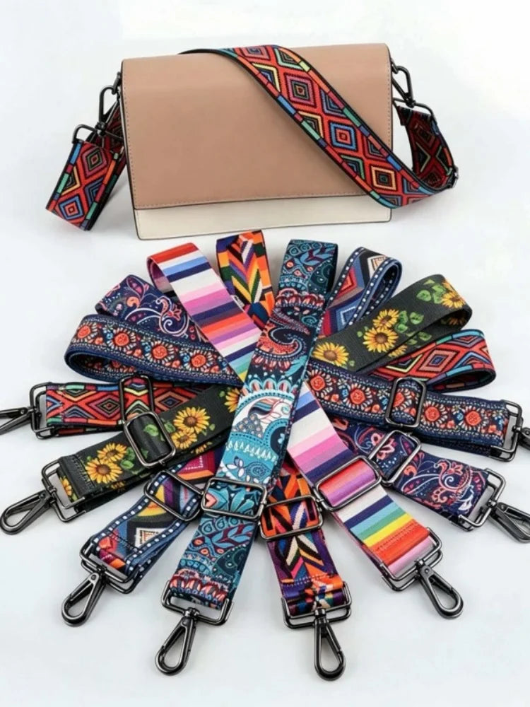 A beige clutch bag with a patterned strap and multiple colorful adjustable crossbody straps displayed on a white background.